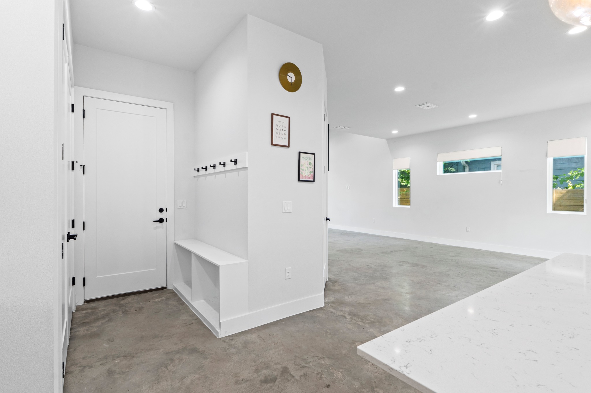 2007 Chestnut Avenue, Unit 1 Austin, TX 78722 - Photo 16 of 32 A well-lit entry area with built-in storage bench and polished concrete flooring flows into a spacious living area.