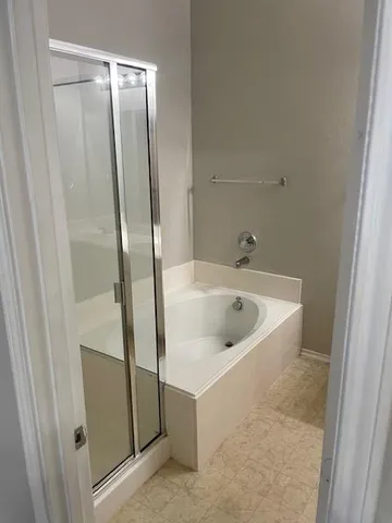 a bathroom with a tub and sink