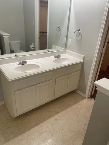 a bathroom with a double vanity sink and mirror