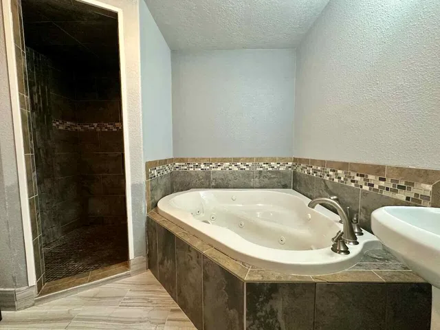 a bathroom with a bathtub and shower