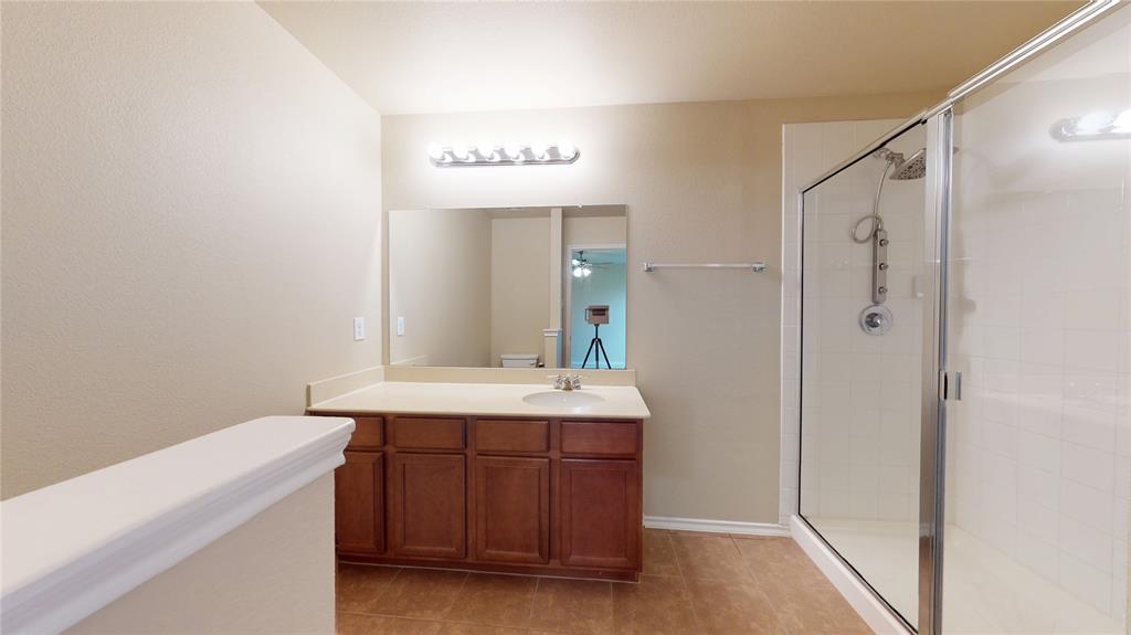 471 Harding Lane Lavon, TX 75166 - Photo 10 of 19 Full bath with vanity, a stall shower, and light tile patterned flooring