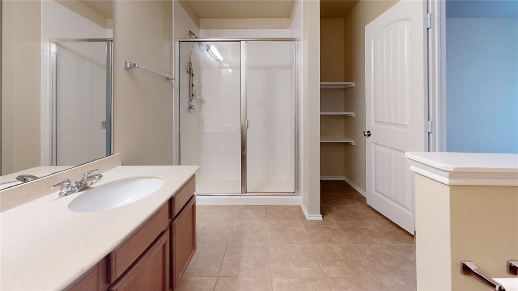 471 Harding Lane Lavon, TX 75166 - Photo 11 of 19 Bathroom with a stall shower, vanity, and light tile patterned flooring