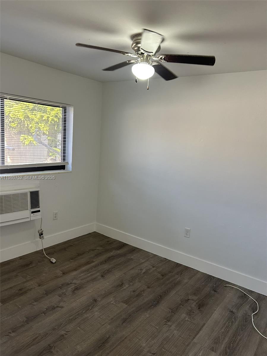 34 West 31st Street, Unit 4 Hialeah, FL 33012 - Photo 4 of 14 an empty room with wooden floor fan and window