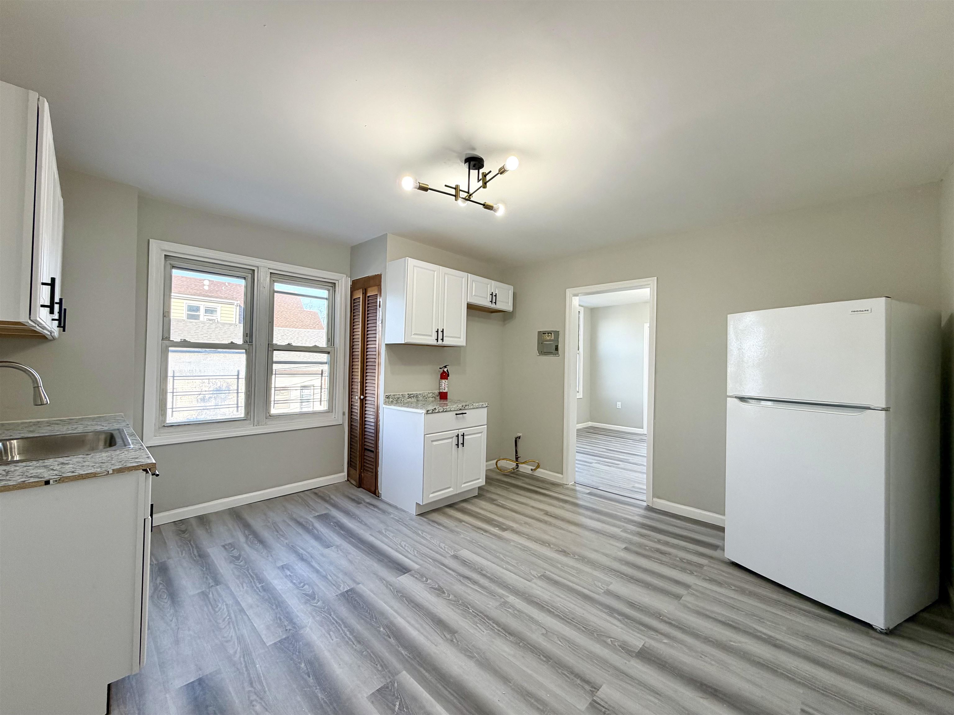 67 Elm Road, Unit 4 Newark, NJ 07105 - Photo 2 of 9 a view of a kitchen with a refrigerator and a stove top oven