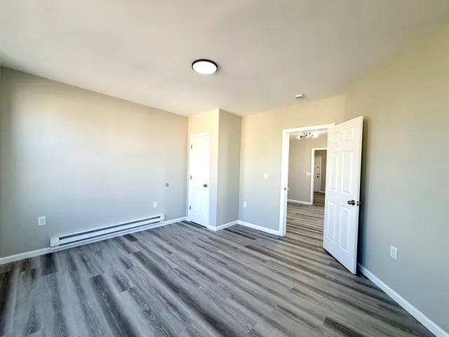 a view of a room with wooden floor