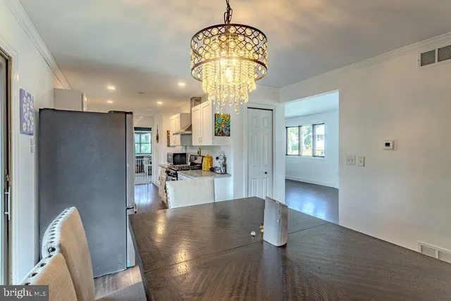 a view of a dining room with furniture wooden floor and a chandelier
