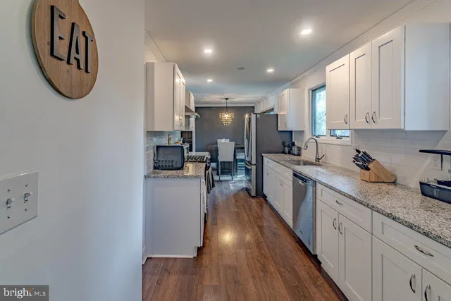a large white kitchen with a large window