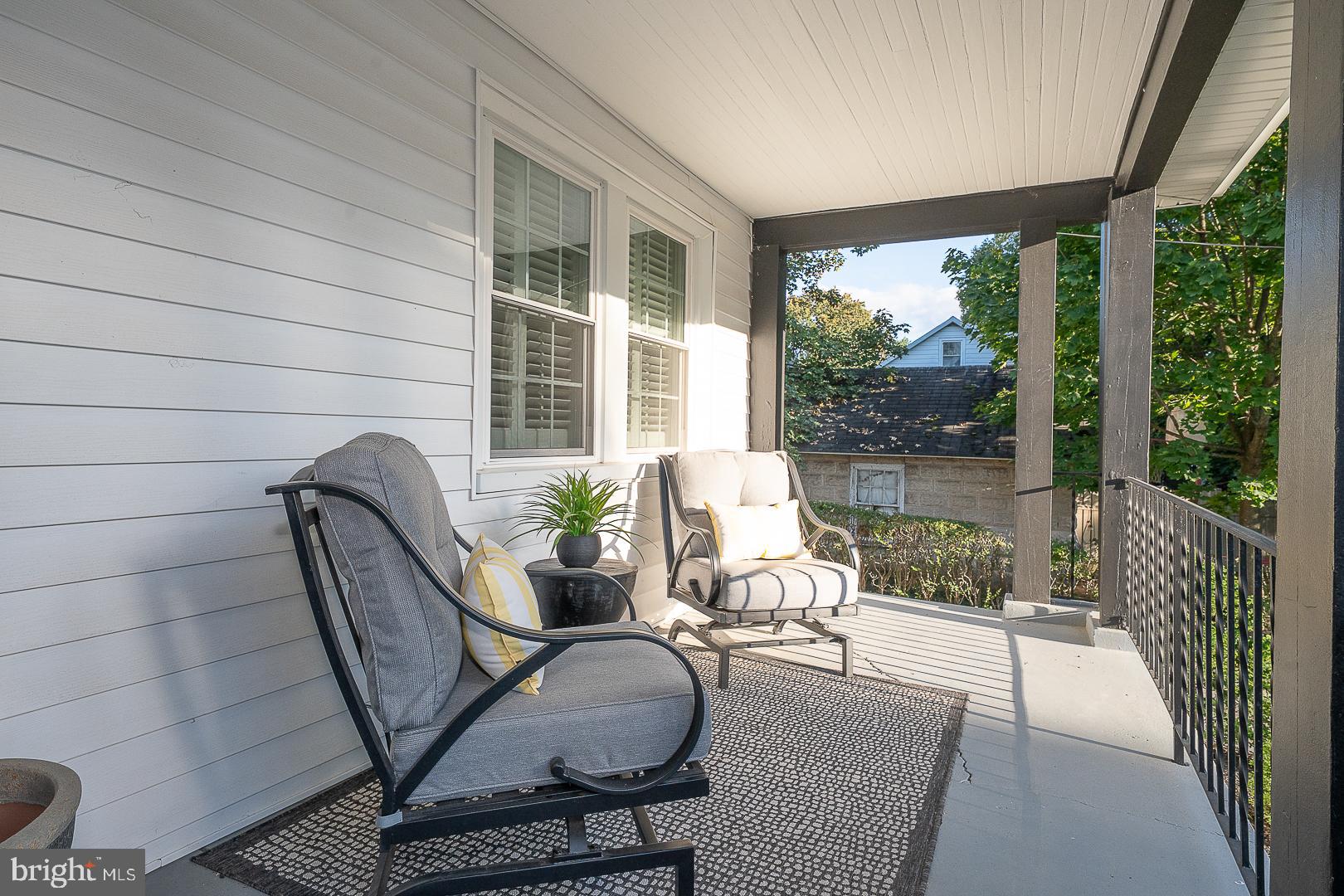 29 Manor Road Paoli, PA 19301 - Photo 5 of 40 a balcony with chairs and a potted plant
