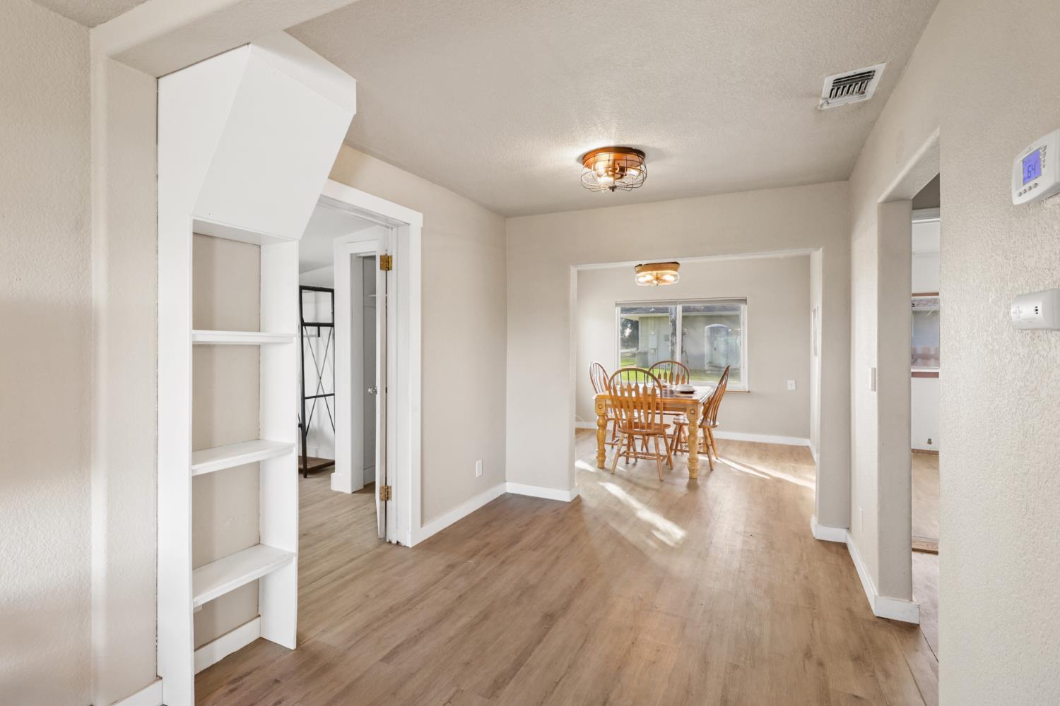 10695 Calvine Road Sacramento, CA 95830 - Photo 3 of 26 a dining room with furniture and wooden floor