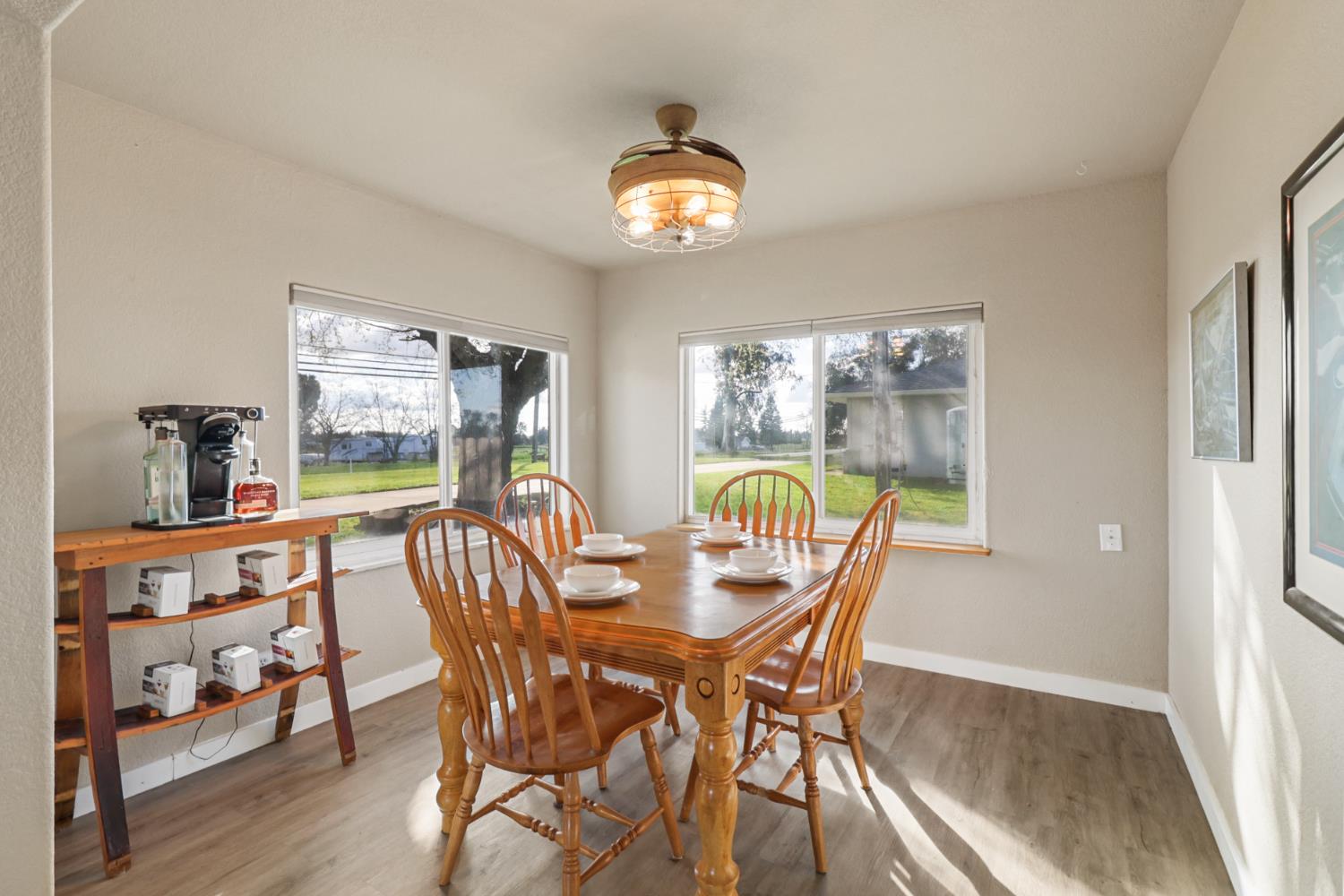 10695 Calvine Road Sacramento, CA 95830 - Photo 4 of 26 a dining room with furniture a chandelier and wooden floor