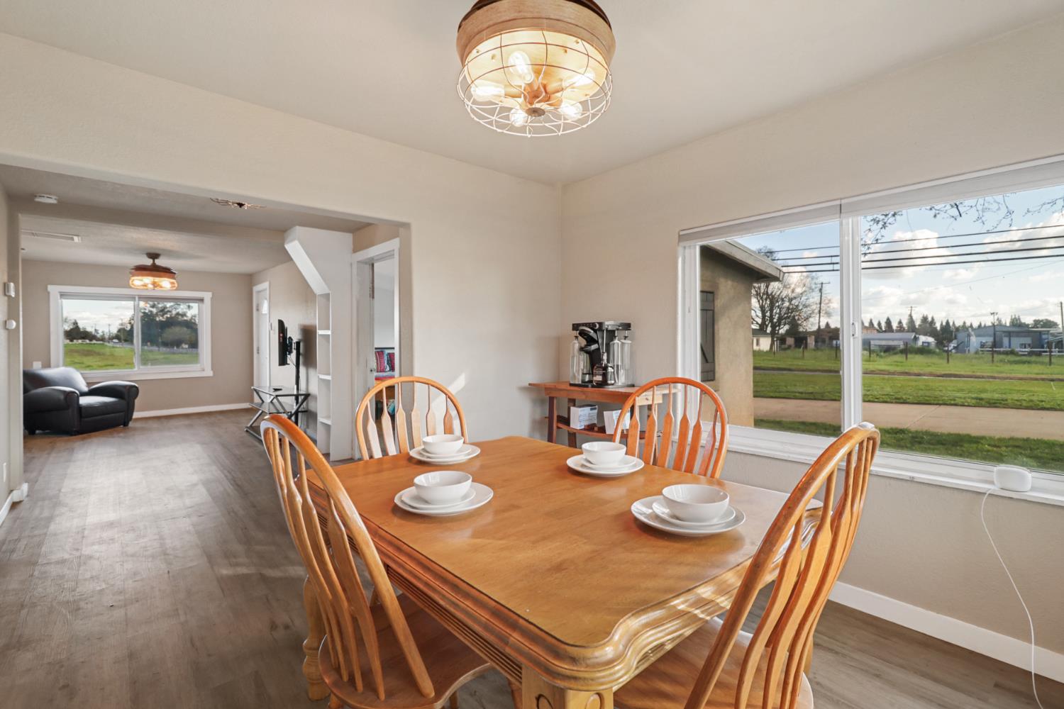 10695 Calvine Road Sacramento, CA 95830 - Photo 5 of 26 a dining room with furniture a chandelier and wooden floor