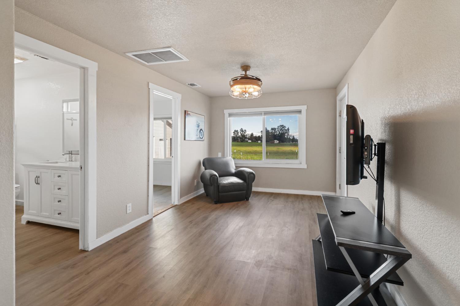 10695 Calvine Road Sacramento, CA 95830 - Photo 7 of 26 a living room with furniture and a wooden floor