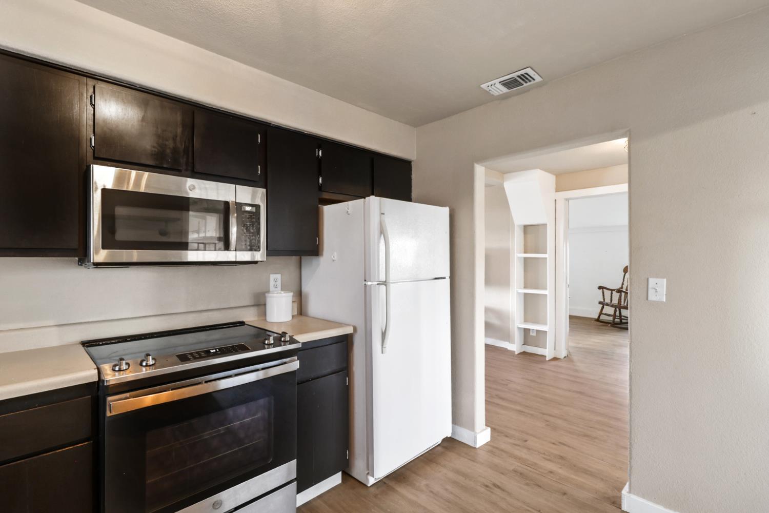 10695 Calvine Road Sacramento, CA 95830 - Photo 10 of 26 a kitchen with a stove and a microwave