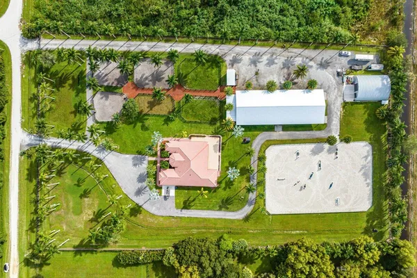an aerial view of a house with a garden and a yard