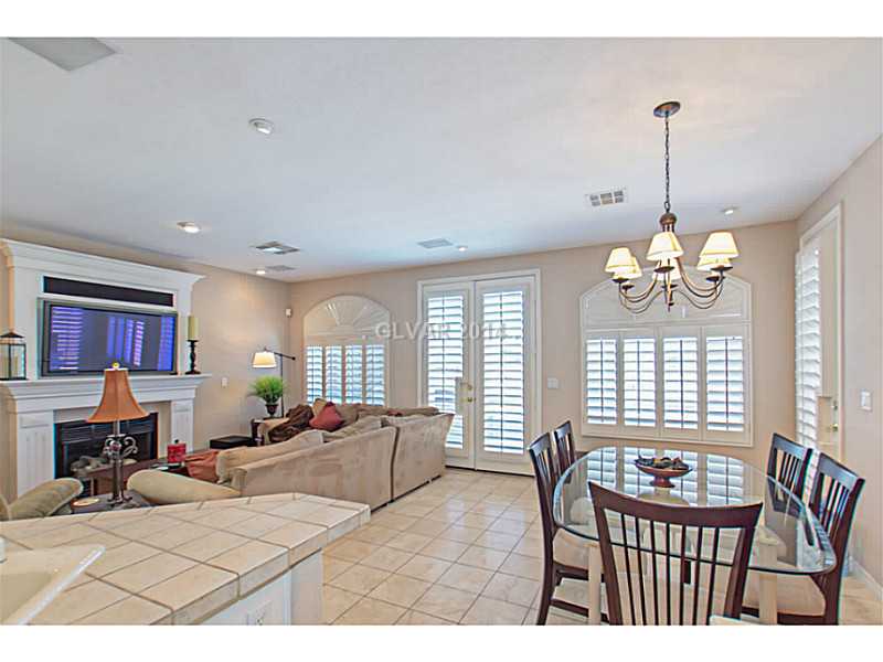905 Collingtree Street Las Vegas, NV 89145 - Photo 34 of 35 Den. Looking into Great Room from Kitchen. Enjoy this open Floorplan w/ Gas Fireplace and Shutters open to reveal Amazing Views. Check out the included Flat Screen w/ Hidden Components
