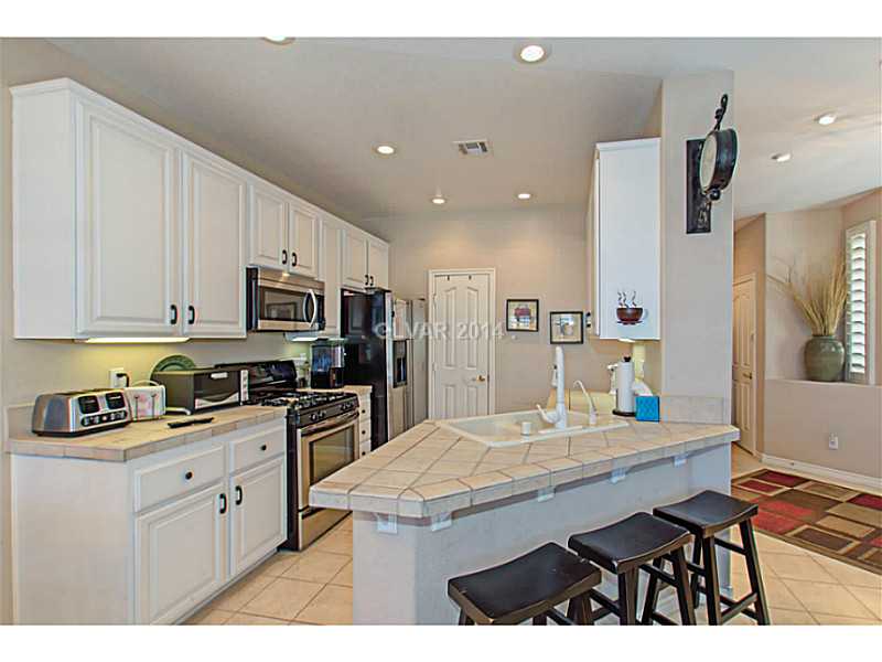 905 Collingtree Street Las Vegas, NV 89145 - Photo 8 of 35 Kitchen. Kitchen Features Breakfast Bar, Tuscon Tile Counters, Stainless Steel Appliances & Pantry