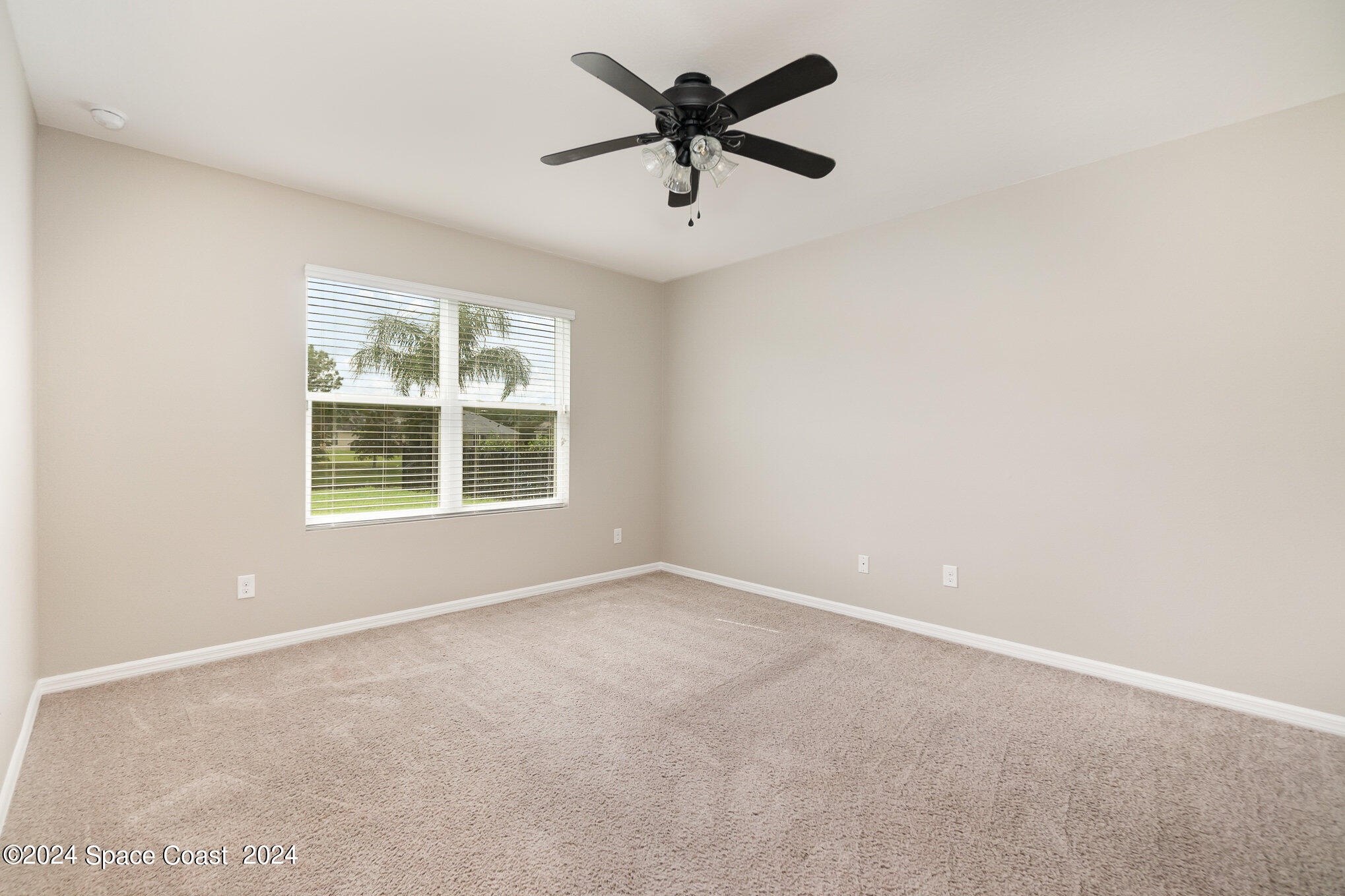 5305 Bear Corn Run Port Orange, FL 32128 - Photo 16 of 33 an empty room with windows and ceiling fan