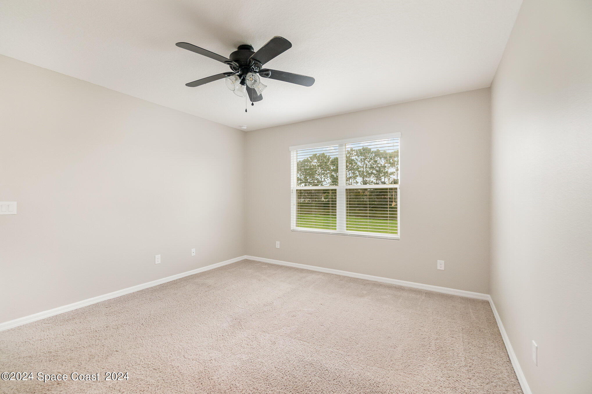 5305 Bear Corn Run Port Orange, FL 32128 - Photo 17 of 33 a view of a big room with a ceiling fan and windows