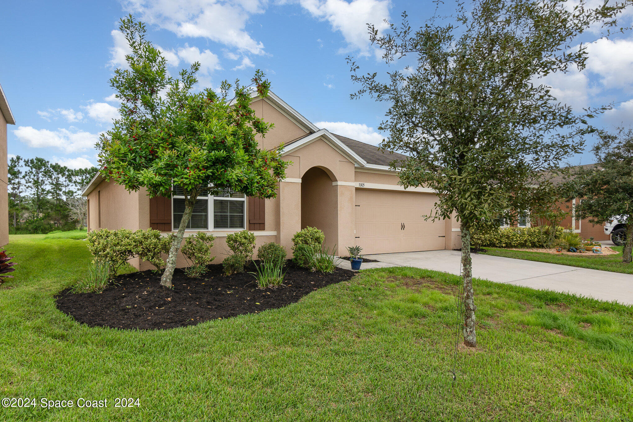 5305 Bear Corn Run Port Orange, FL 32128 - Photo 2 of 33 a front view of a house with a yard and garage