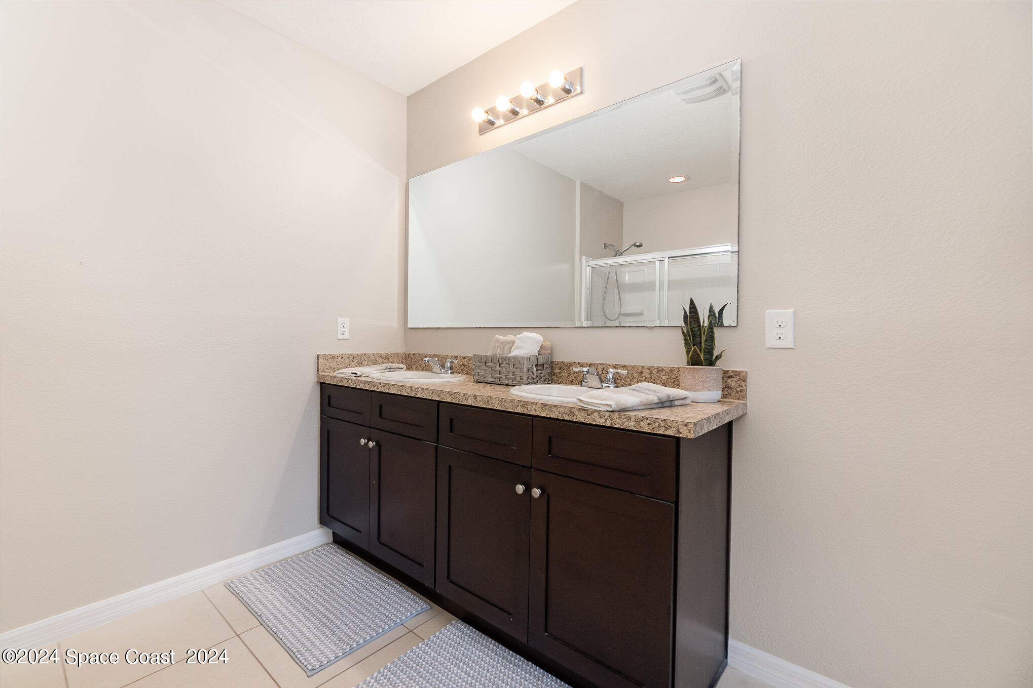 5305 Bear Corn Run Port Orange, FL 32128 - Photo 21 of 33 a bathroom with a granite countertop sink and a mirror