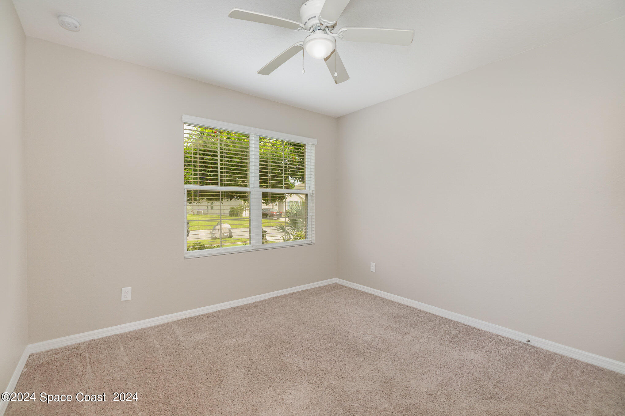5305 Bear Corn Run Port Orange, FL 32128 - Photo 22 of 33 an empty room with a window and a ceiling fan