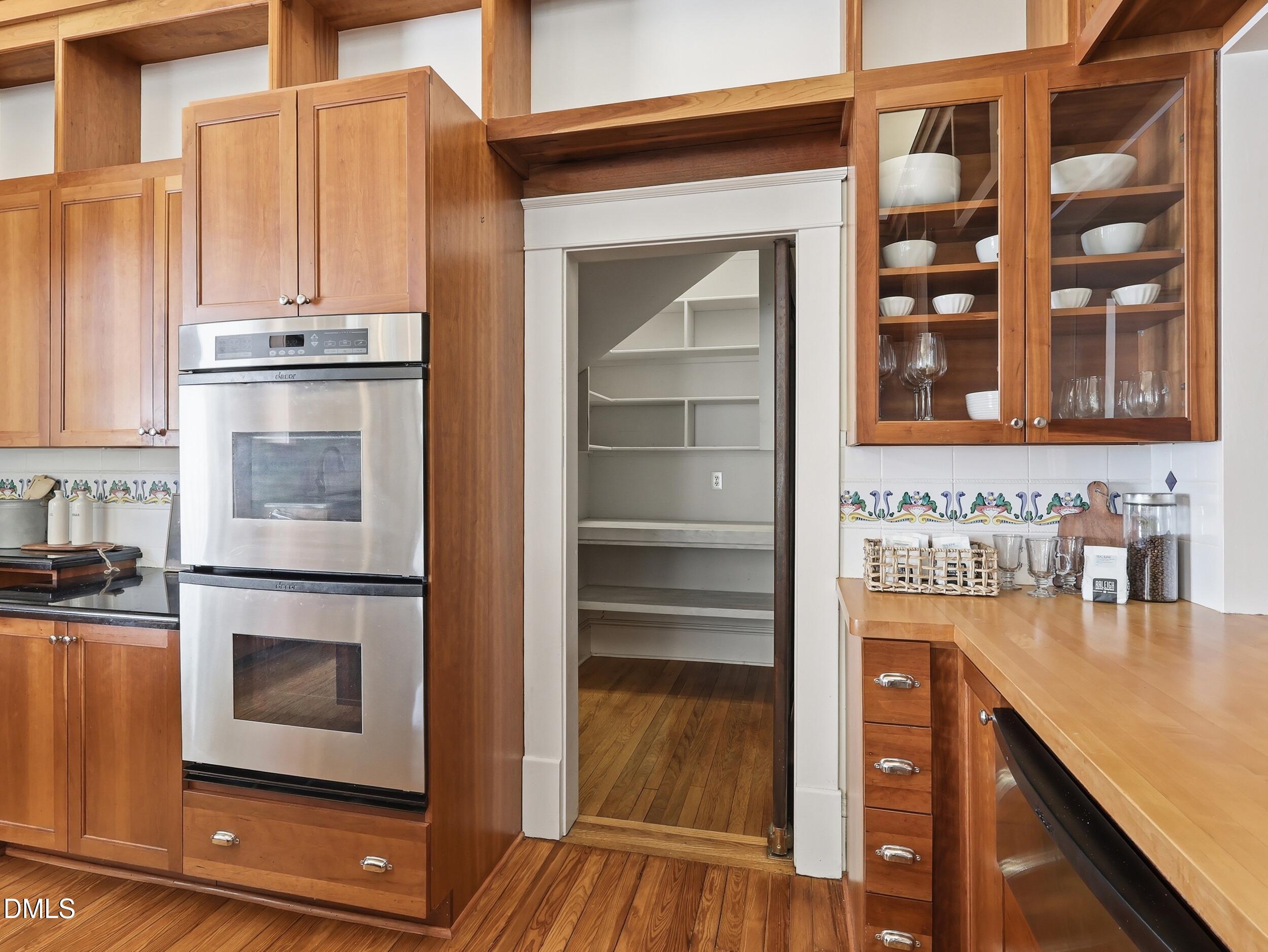 127 Forest Road Raleigh, NC 27605 - Photo 27 of 75 a kitchen with stainless steel appliances a stove and a refrigerator