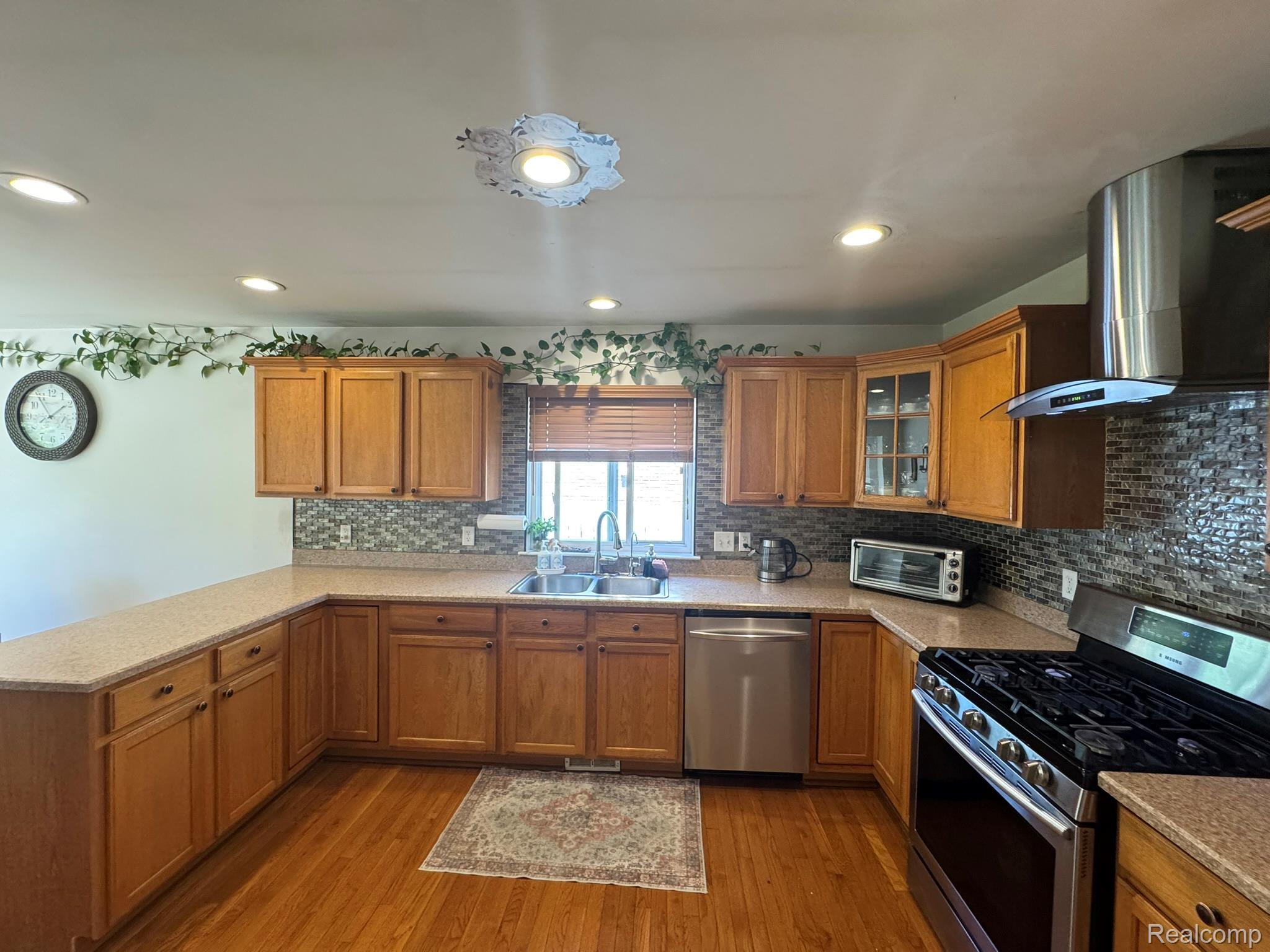 324 Cherry Lane Inkster, MI 48141 - Photo 9 of 28 Kitchen featuring U-shaped counter space, wood-finish flooring, and recessed lighting