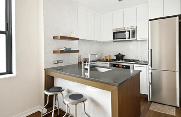 a kitchen with stainless steel appliances granite countertop a sink a refrigerator and a stove