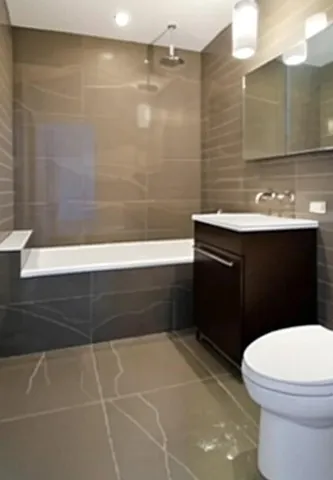 a bathroom with a sink a toilet a mirror and bathtub