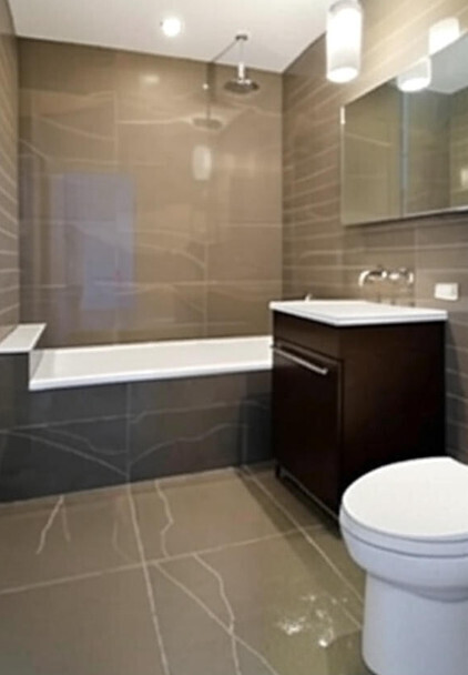 58 Metropolitan Avenue, Unit 2B Brooklyn, NY 11249 - Photo 2 of 11 a bathroom with a sink a toilet a mirror and bathtub