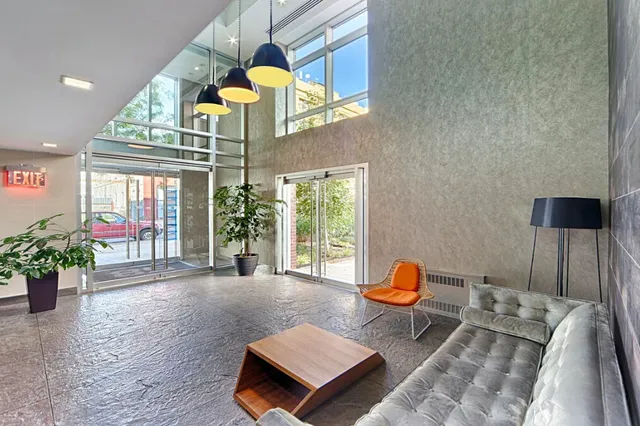 a living room with furniture flowerpot and wooden floor