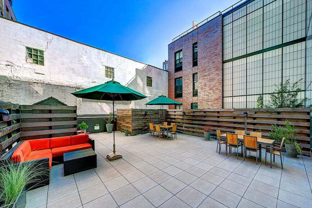 58 Metropolitan Avenue, Unit 2B Brooklyn, NY 11249 - Photo 5 of 11 a backyard of a house with barbeque oven table and chairs
