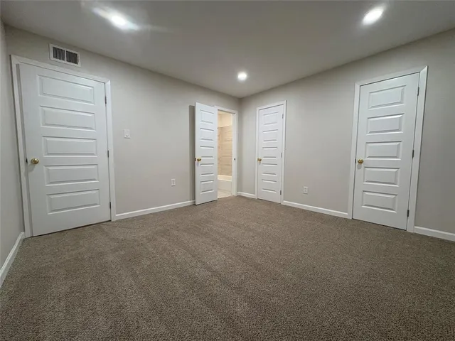 a view of an empty room and closet area