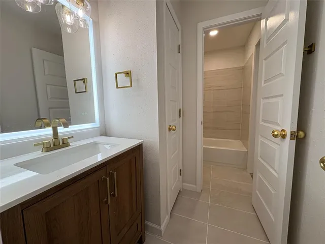 a bathroom with a granite countertop sink a mirror and a shower
