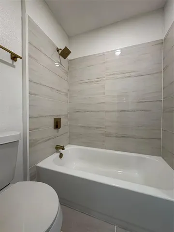 a white bath tub sitting next to a white toilet