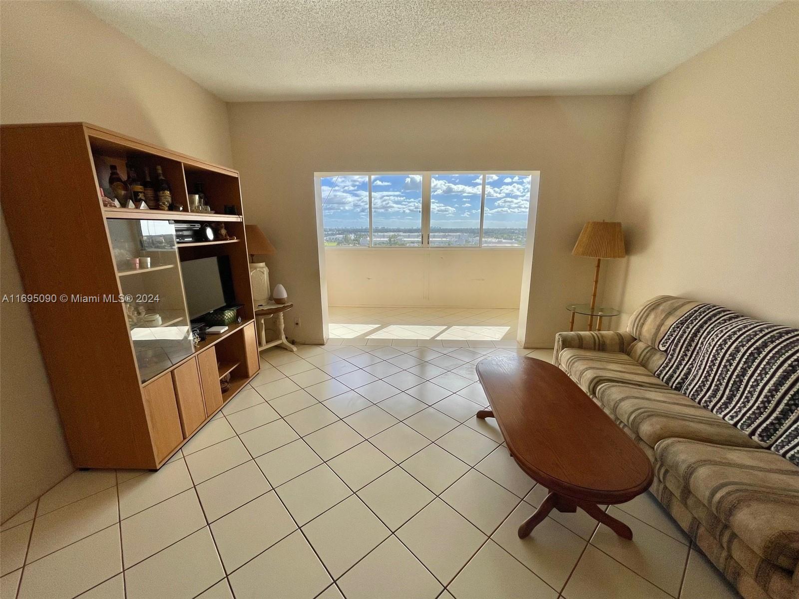 Hillcrest Hollywood, FL 33021 - Photo 3 of 29 a living room with furniture and a flat screen tv