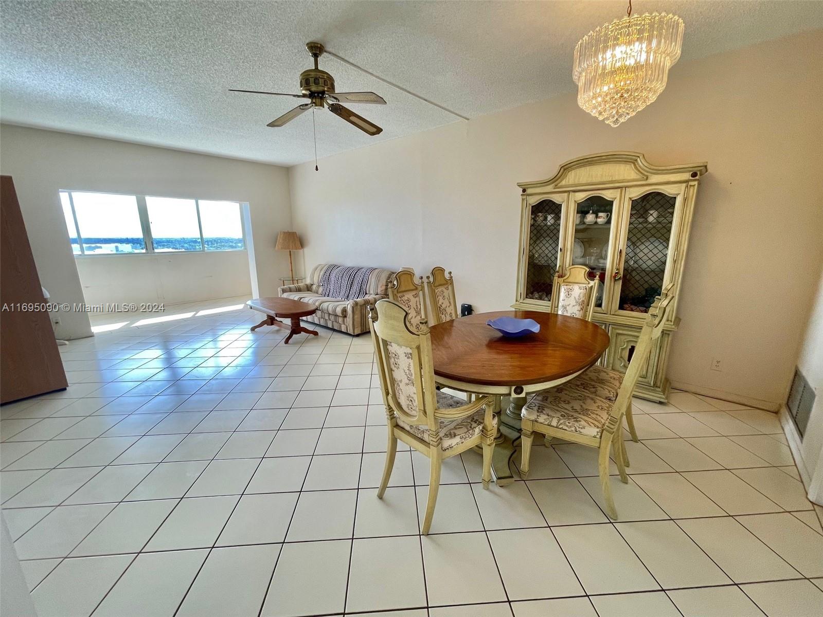 Hillcrest Hollywood, FL 33021 - Photo 4 of 29 a dining room with furniture and a chandelier