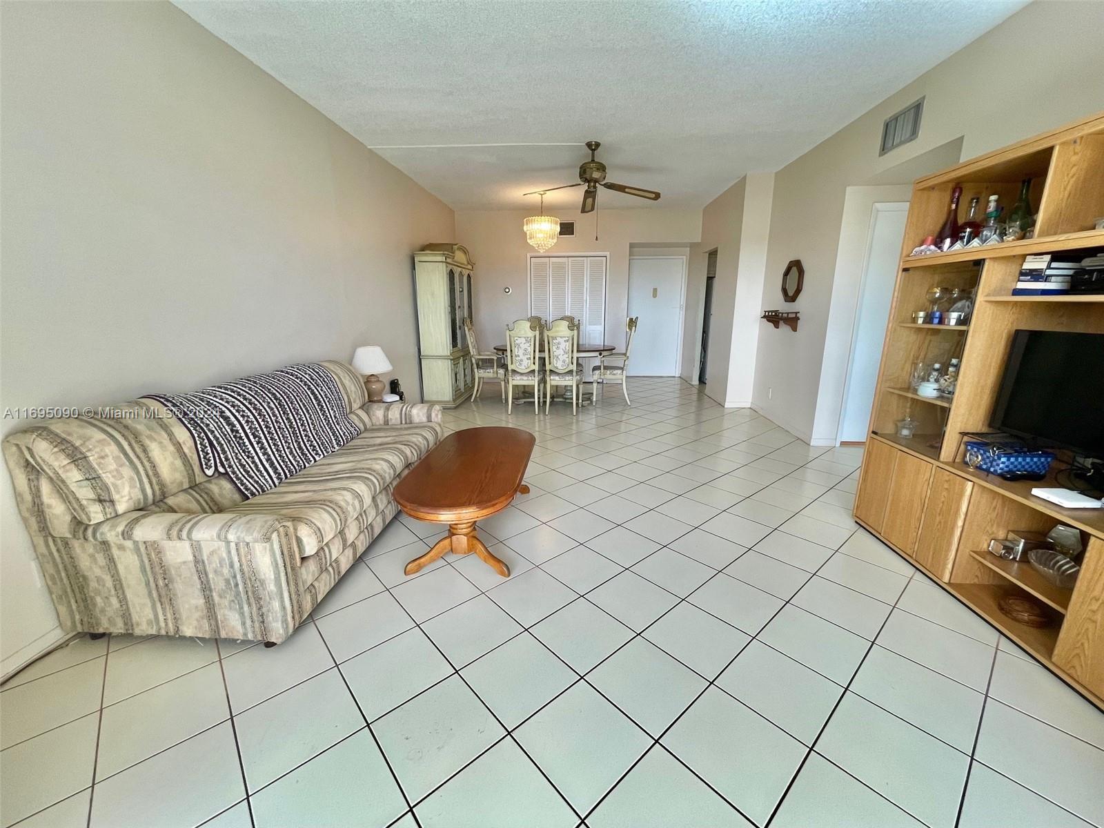 Hillcrest Hollywood, FL 33021 - Photo 5 of 29 a living room with furniture a flat screen tv and rug
