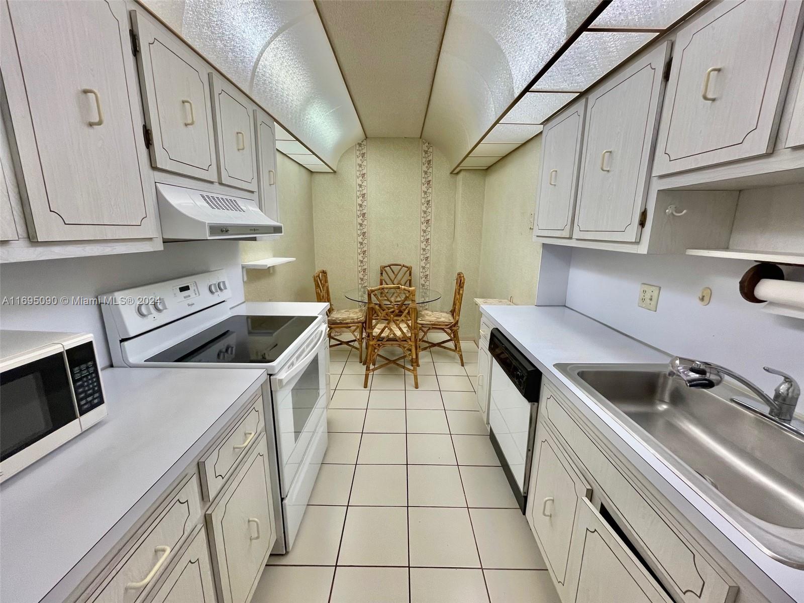Hillcrest Hollywood, FL 33021 - Photo 6 of 29 a kitchen that has a sink and a stove