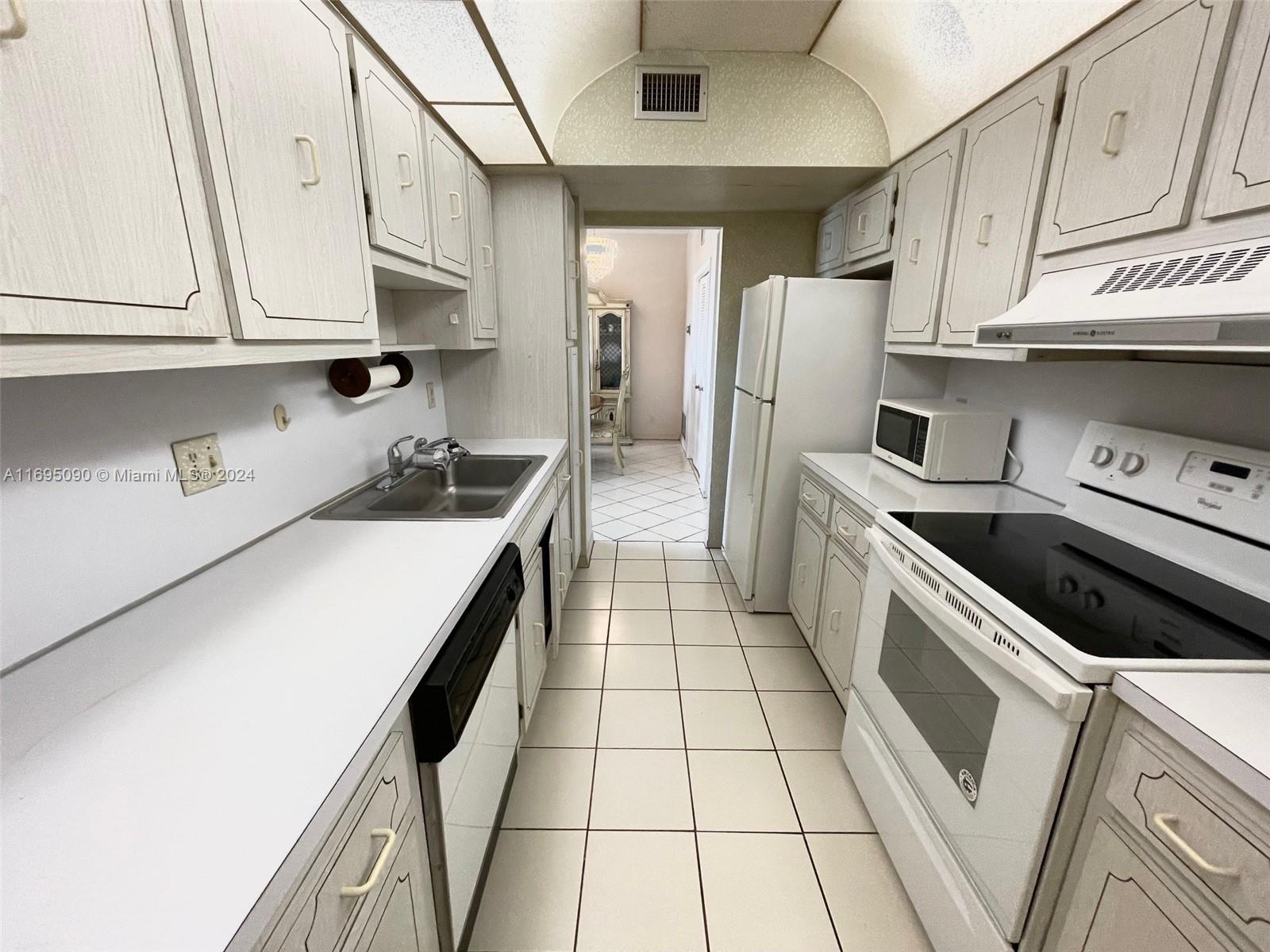 Hillcrest Hollywood, FL 33021 - Photo 7 of 29 a kitchen with stainless steel appliances a stove a sink and cabinets