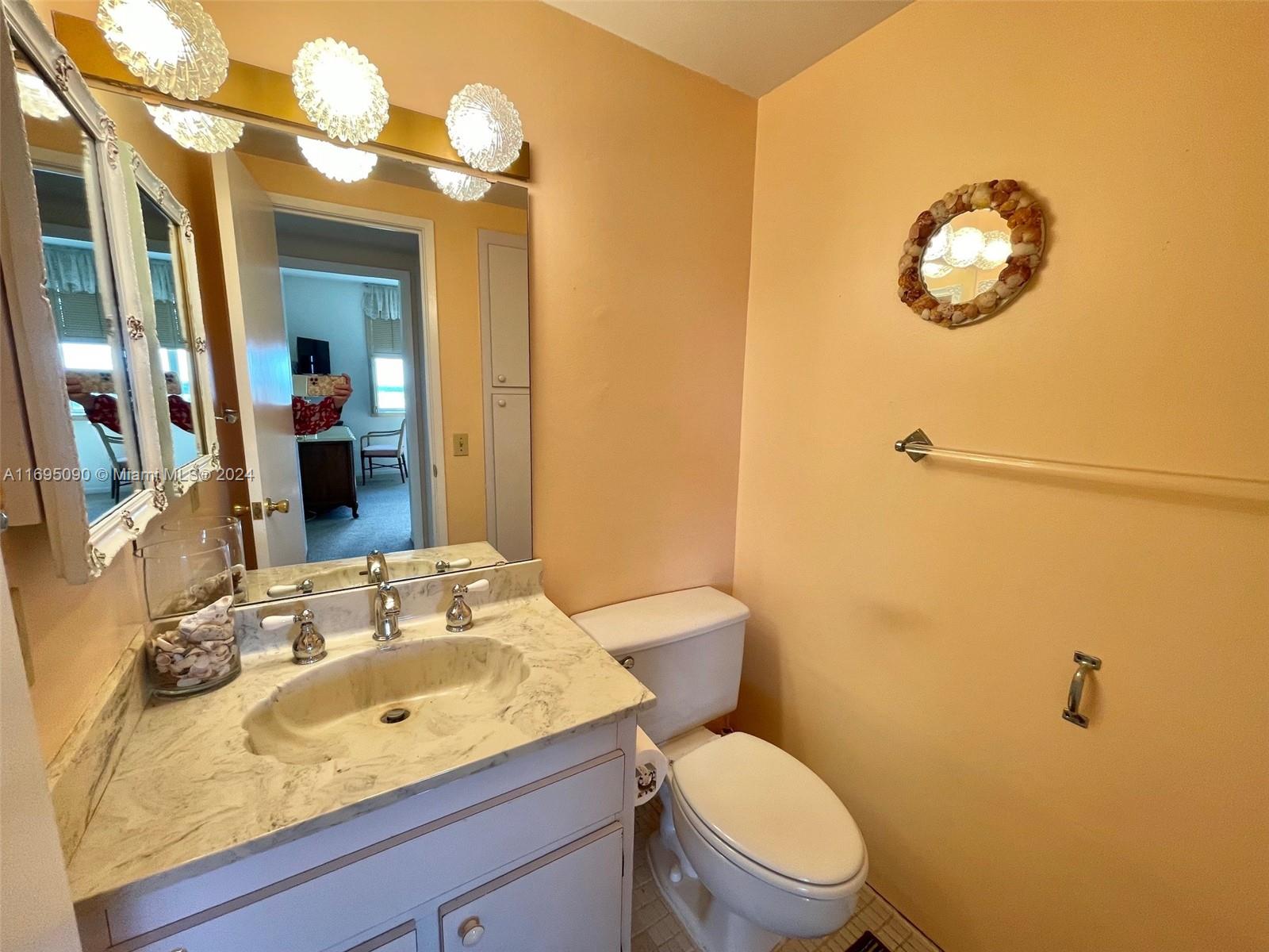 Hillcrest Hollywood, FL 33021 - Photo 8 of 29 a bathroom with a sink vanity mirror and toilet