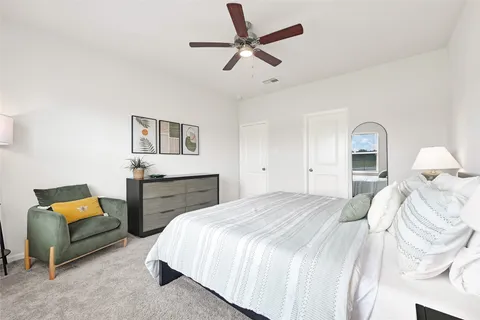 a bedroom with a bed and a couch