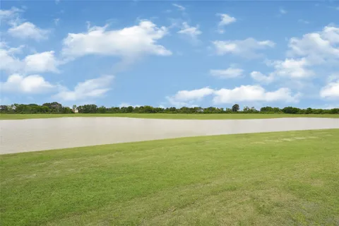 a view of a lake with houses in the background