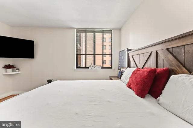 a bedroom with a bed and flat screen tv