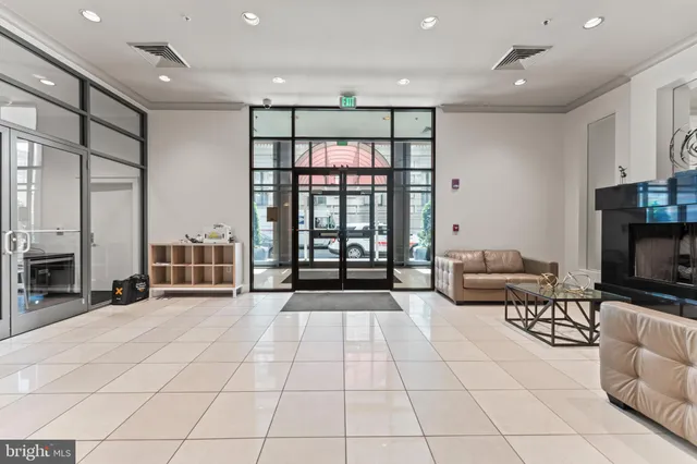 a view of a livingroom with furniture and floor to ceiling window