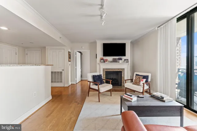 a living room with furniture a fireplace and a flat screen tv