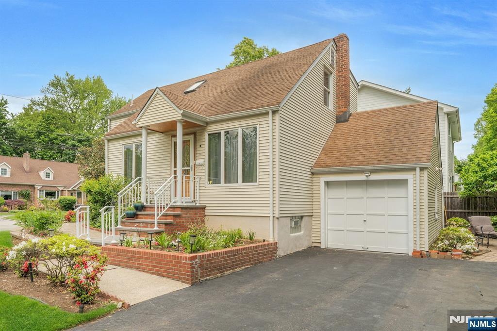 24 Cambridge Road Tenafly, NJ 07670 - Photo 3 of 31 front view of a house with a yard