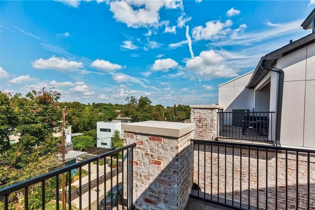 a view of a balcony with wooden chairs