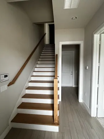 a view of entryway and hall with wooden floor