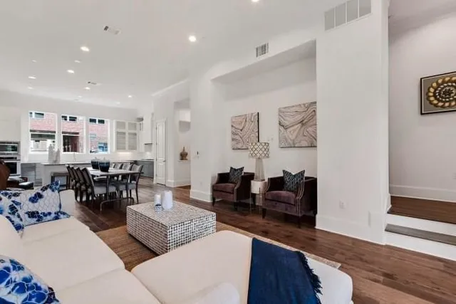 a living room with furniture and wooden floor